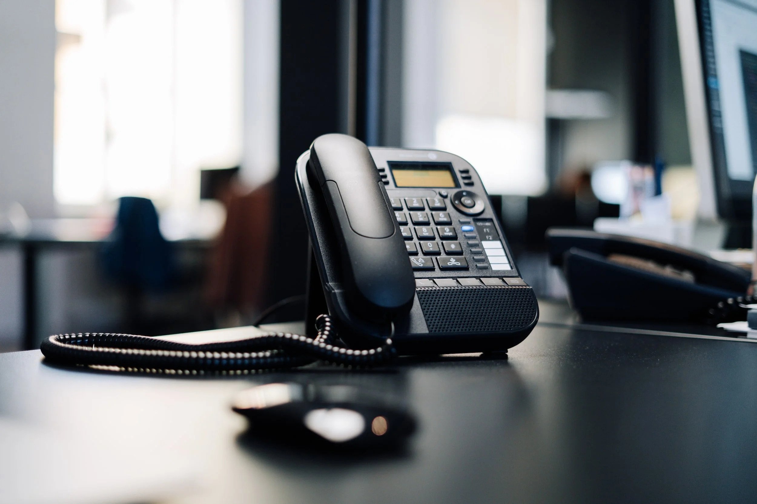 Office telephone ready for dispatch calls on an empty desk