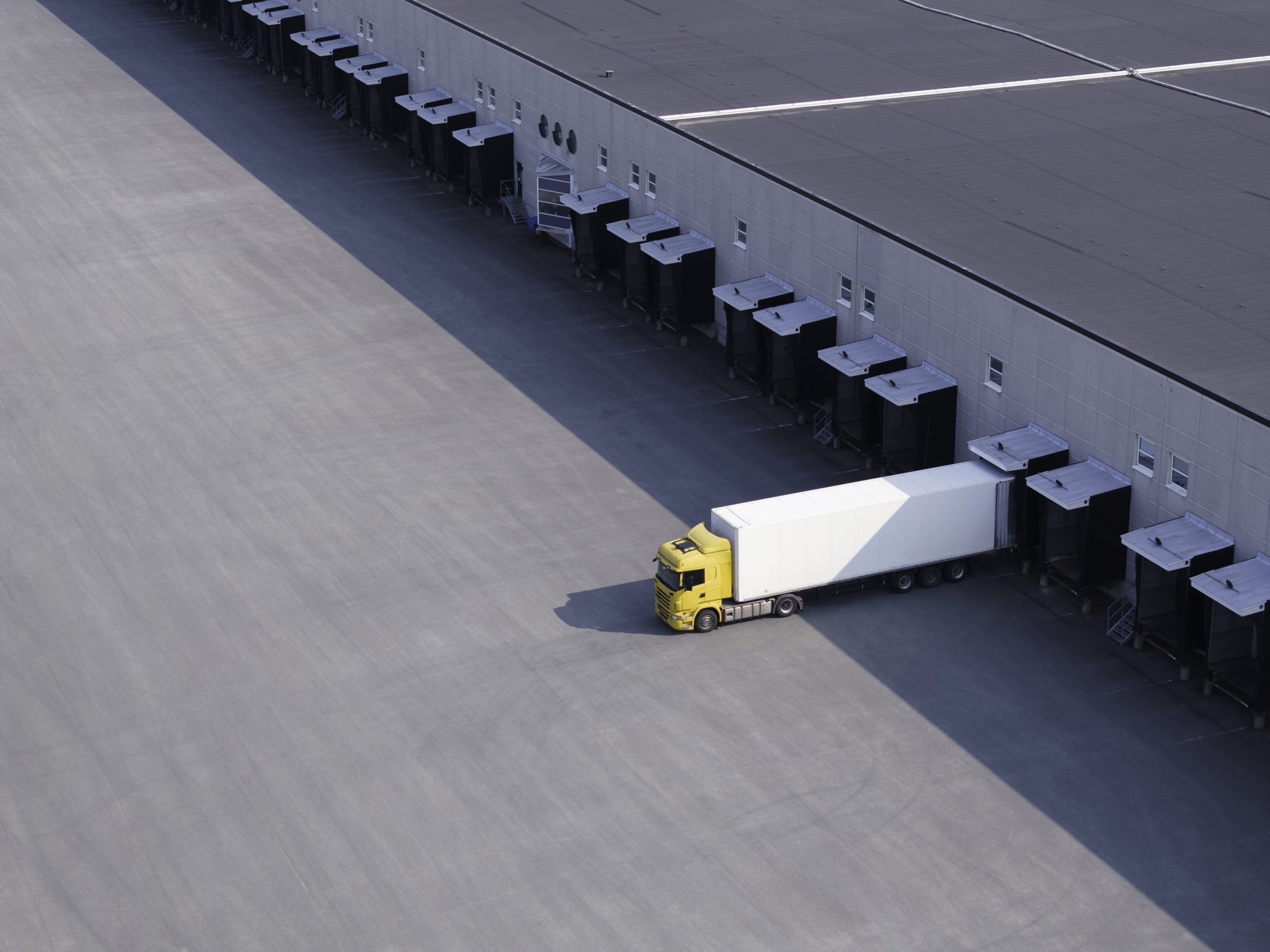 Commercial freight truck backed into a warehouse loading dock