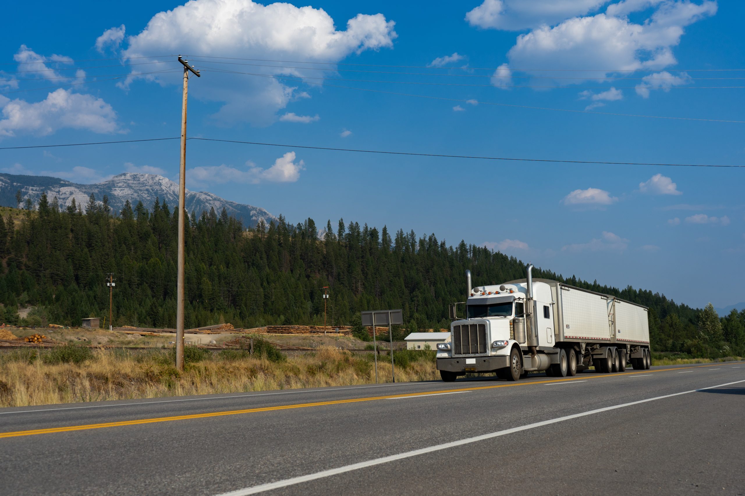 Semi tractor-trailer carrying dry-van freight on an open highway